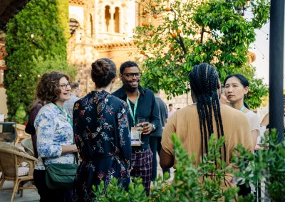 A group of symposium participants sharing a lively conversation during the DNSG 2026 reception.