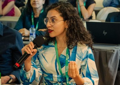 Attendee asking a question with a microphone during a DNSG 2026 scientific discussion.