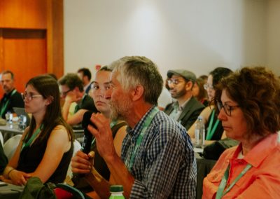Participant speaking into a microphone during the question-and-answer session at DNSG 2026.