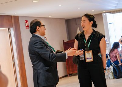 Two DNSG 2026 attendees talking during a break between scientific sessions.