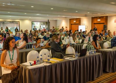 Wide view of attendees following a scientific presentation during the DNSG 2026 symposium.