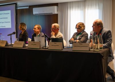 Five experts seated at the panel table during a scientific session at the DNSG 2026 symposium.