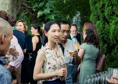 Two attendees talking beside a drinks table during the outdoor DNSG 2026 reception.