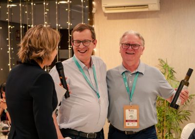 Two participants smiling during an award presentation at the DNSG 2026 symposium dinner.