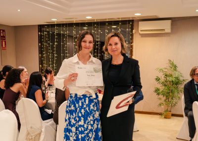 DNSG 2026 participant holding a best poster award certificate beside the event presenter.