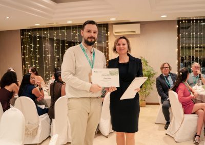 DNSG 2026 participant receiving a young investigator award certificate during the symposium dinner.