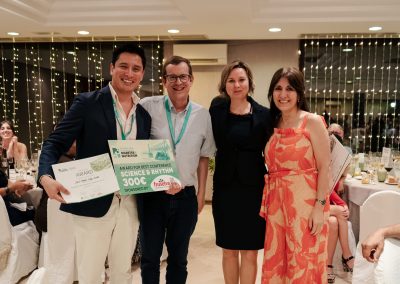Award recipient posing with organisers and the best conference science and rhythm prize at DNSG 2026.