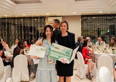 DNSG 2026 participant displaying an award certificate and sponsored prize beside the event presenter.