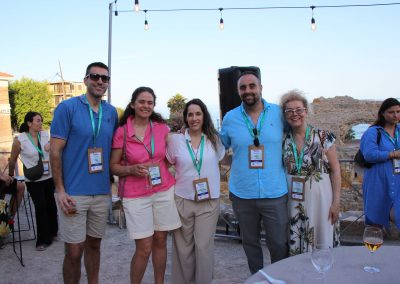 Five DNSG 2026 attendees posing together during an outdoor reception overlooking the historic venue.