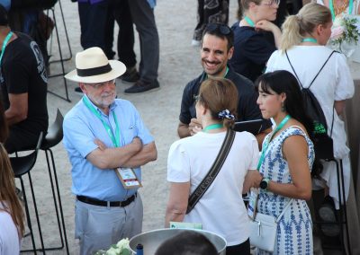Four symposium participants talking together during an outdoor networking reception at DNSG 2026.